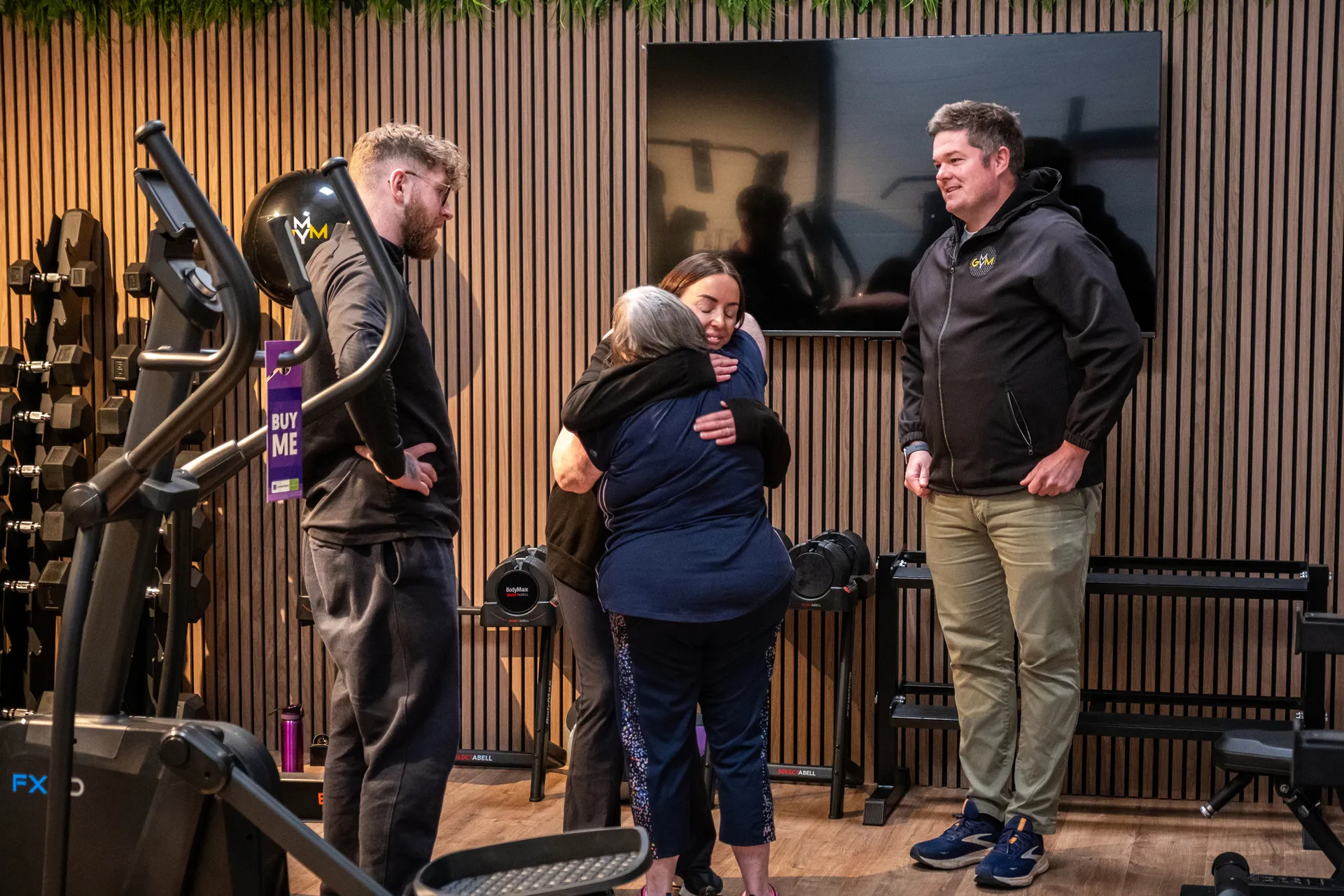 Julie Naylor sharing a hug with the MyGym team during filming